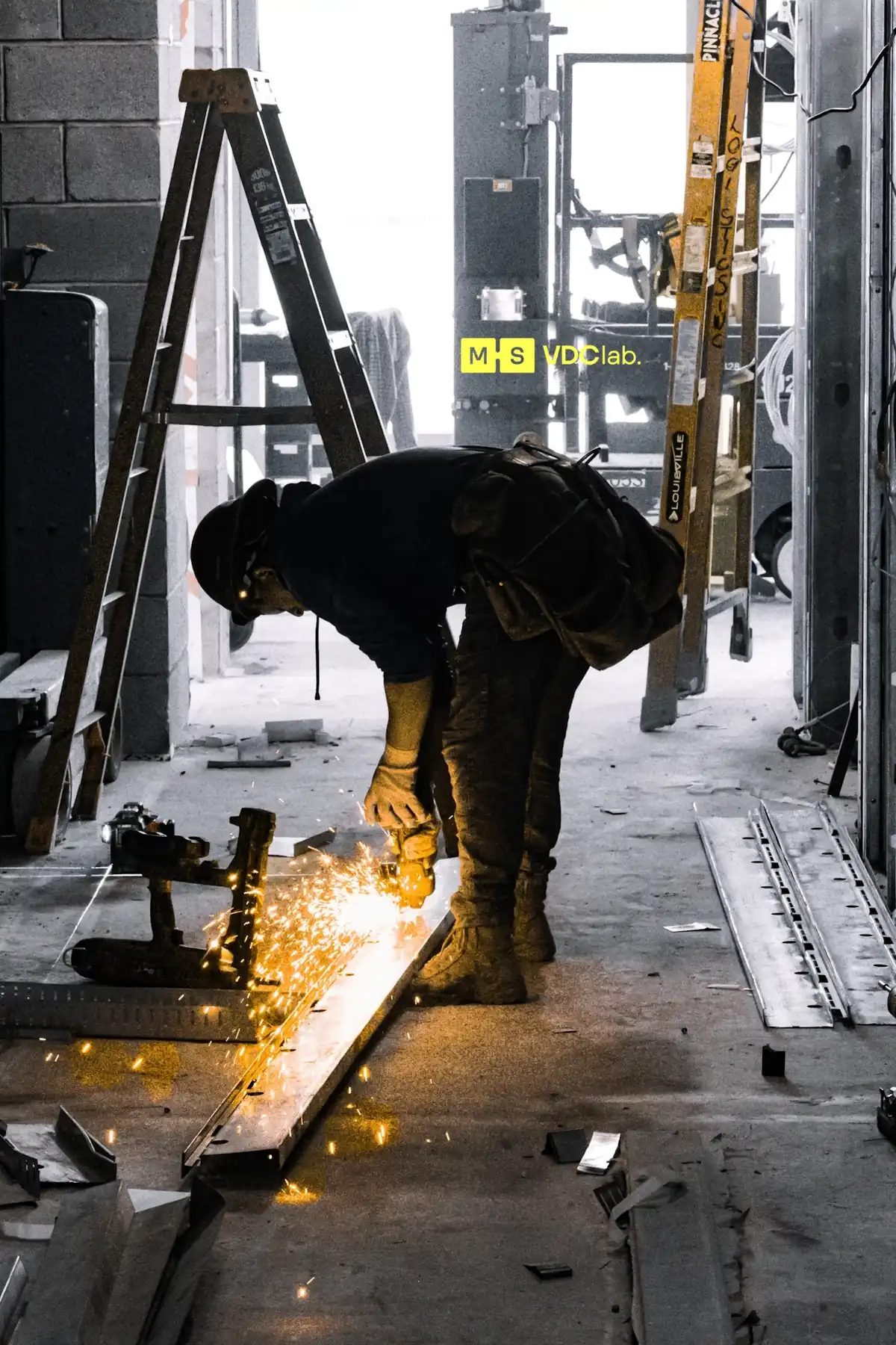 Crew member cutting steel on a construction site