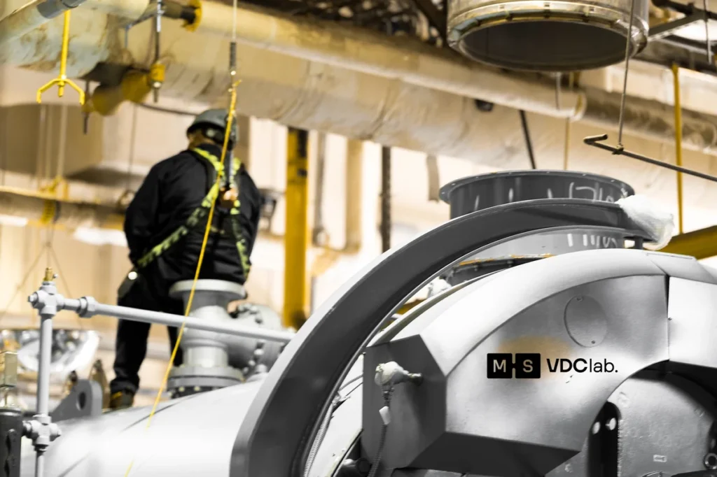VDClab technician on site in a mechanical room verifying existing conditions before drawing