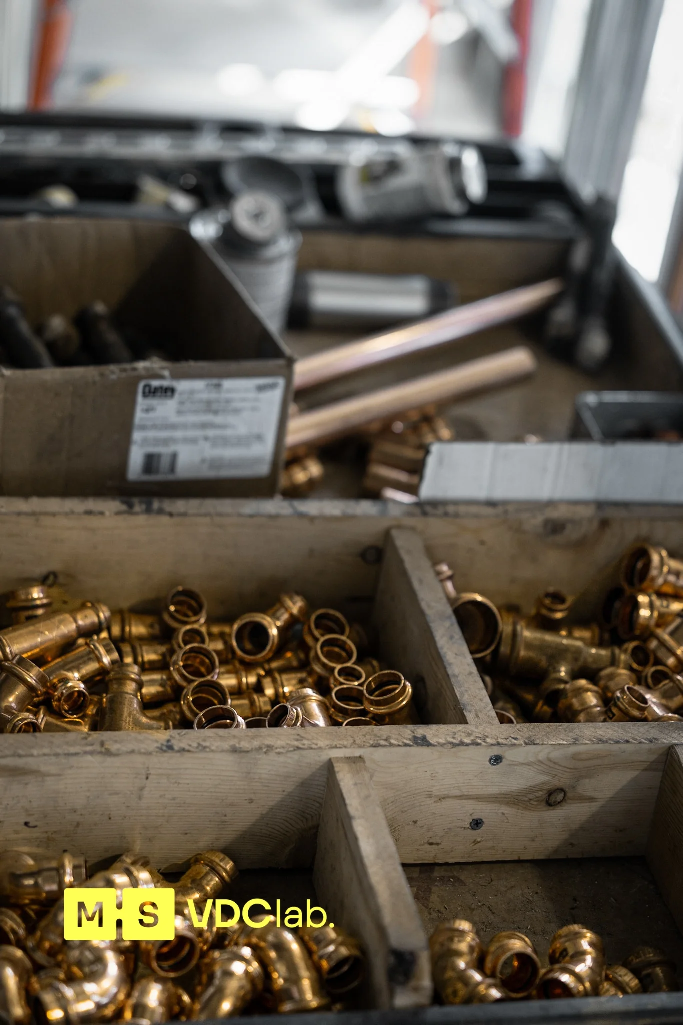 Copper press fittings organized for a plumbing rough-in, take-off from the model